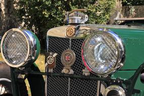 Beautiful, retro. green oldtimer car with headlights, from the 20's