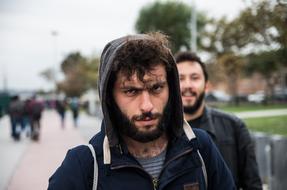 guys on a city street in a blurry background