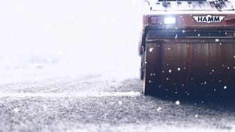 Roller vehicle with light, on the beautiful road in snow