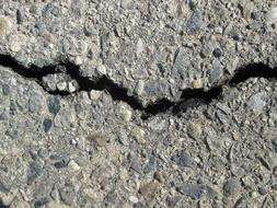 cracked asphalt on the sidewalk