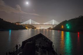 Beautiful landscape with the Centennial Bridge above the Panama Canal, with colorful lights at night