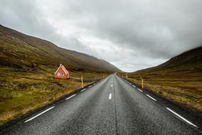 asphalt highway among the hills on a cloudy day