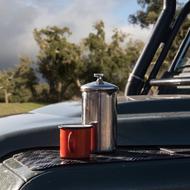 cup and metal teapot