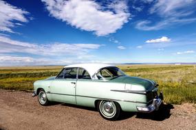 blue sky over green oldtimer