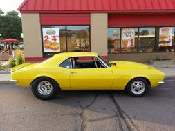 Chevrolet Camaro, Yellow muscle car on street