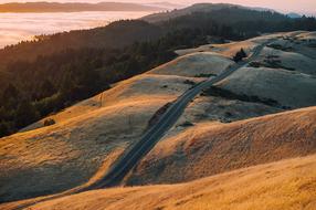 panoramic view of the road in the hills at sunrise