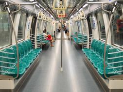 green chairs in a modern subway car