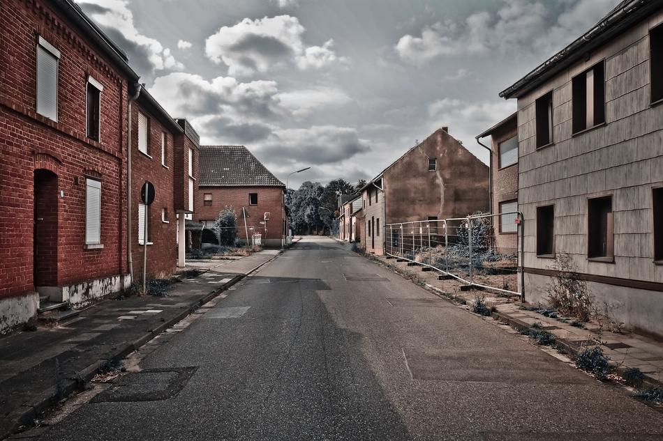Beautiful road, among the buildings, under cloudy sky