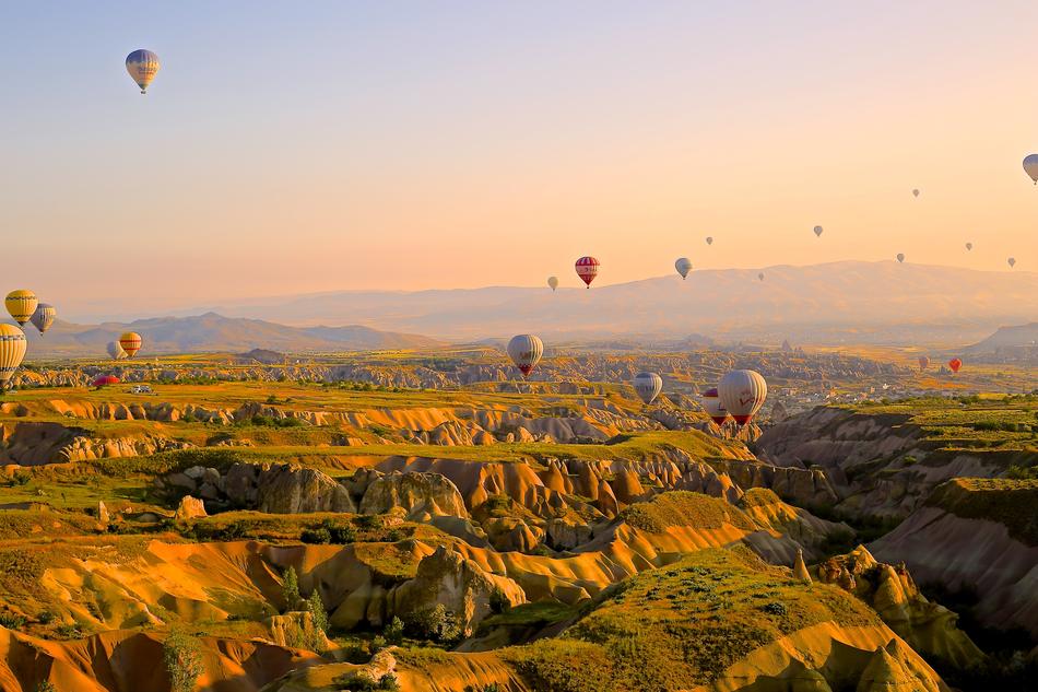 Hot Air Ballons over picturesque landscapes at sunset