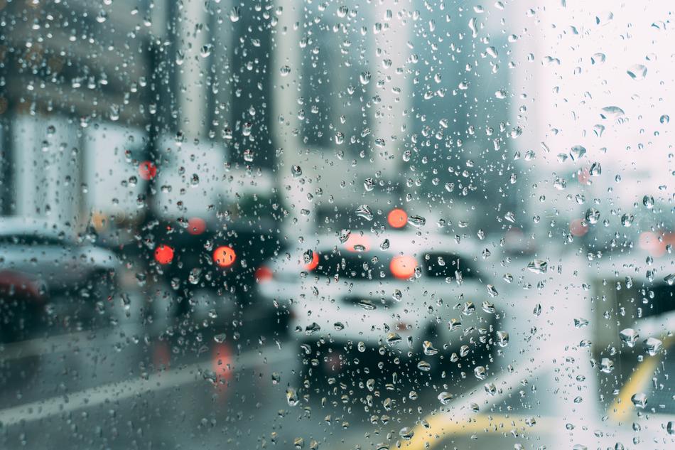 macro view of water Dew on window and Blur Cars
