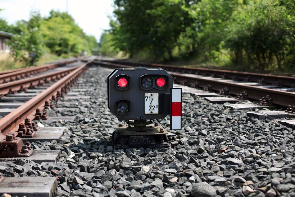 Signal machine on the pebbles, among the railway, among the green plants