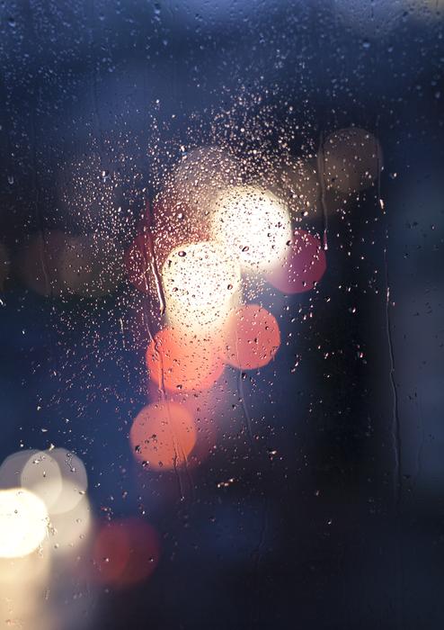 car lights through a wet window