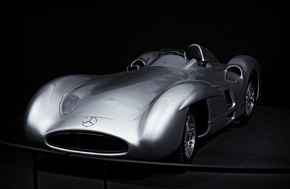 Grey shining classic racing car in the darkness