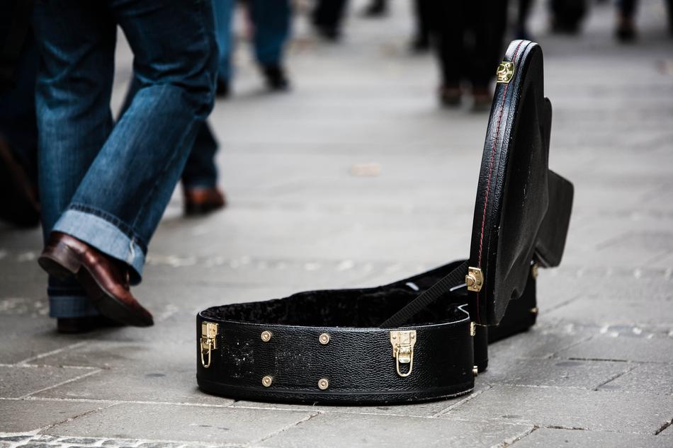 donations, opened a black case for the guitar in the street