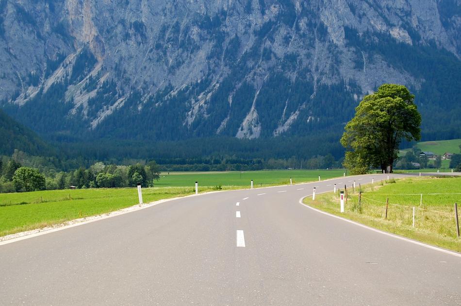 photo of a flat highway against the background of the Alps