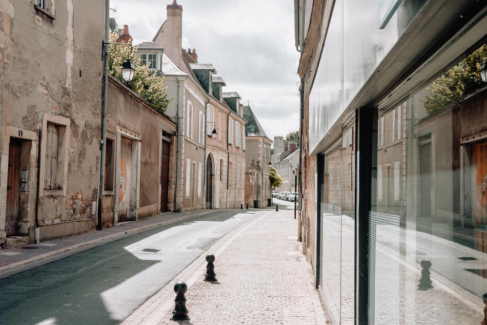 Beautiful landscape of the street with the houses in France, under the cloudy sky