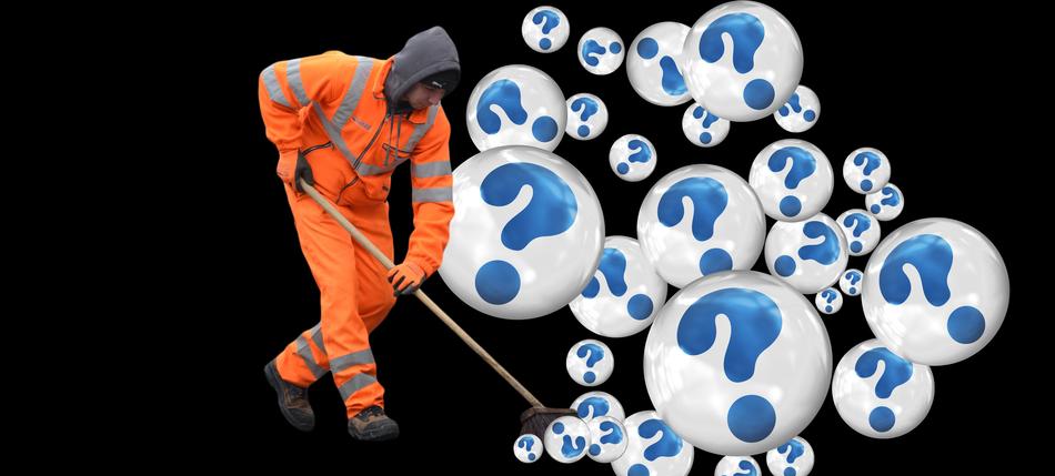 worker sweeps bubbles with a question mark