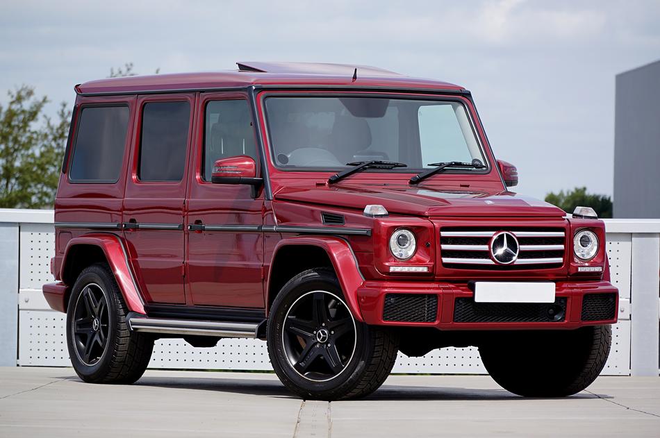 Beautiful, shiny, red Mercedes-Benz g350d, at cloudy sky on background