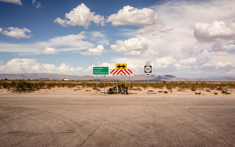 signs on a wide road on a sunny day