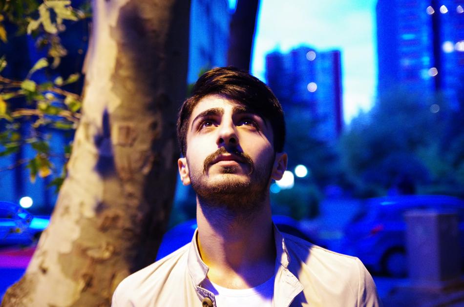 Portrait of the person at background with buildings in blue light