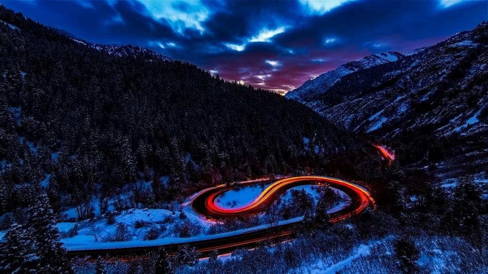 Beautiful landscape of the snowy mountains with colorful lights in movement, in the valley