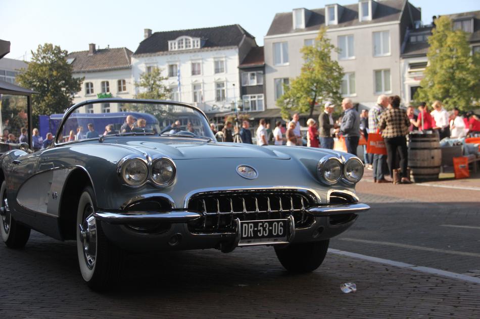 Beautiful, shiny Corvette car of Sittard Klassiek, near the buildings and people