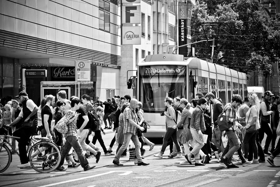 Black and white photo with the train near the people in Düsseldorf, Germany