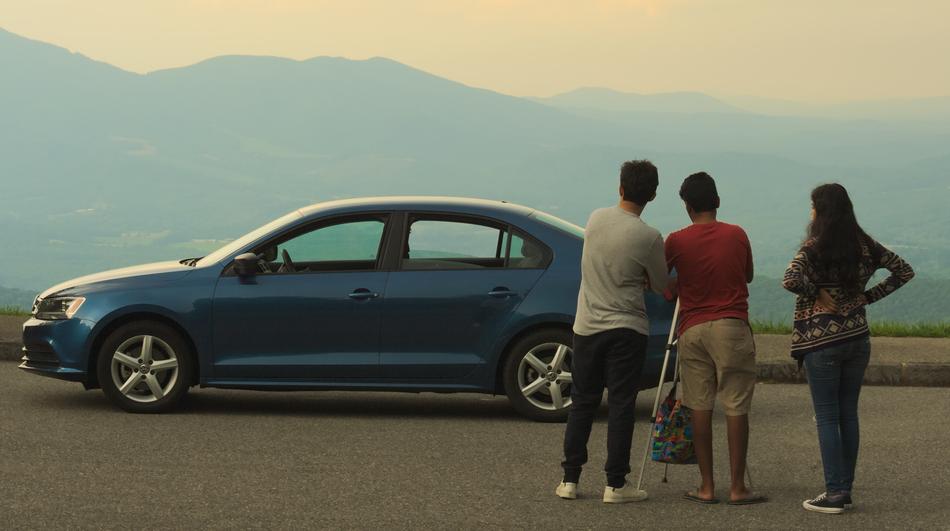 Beautiful landscape with the people near the blue car