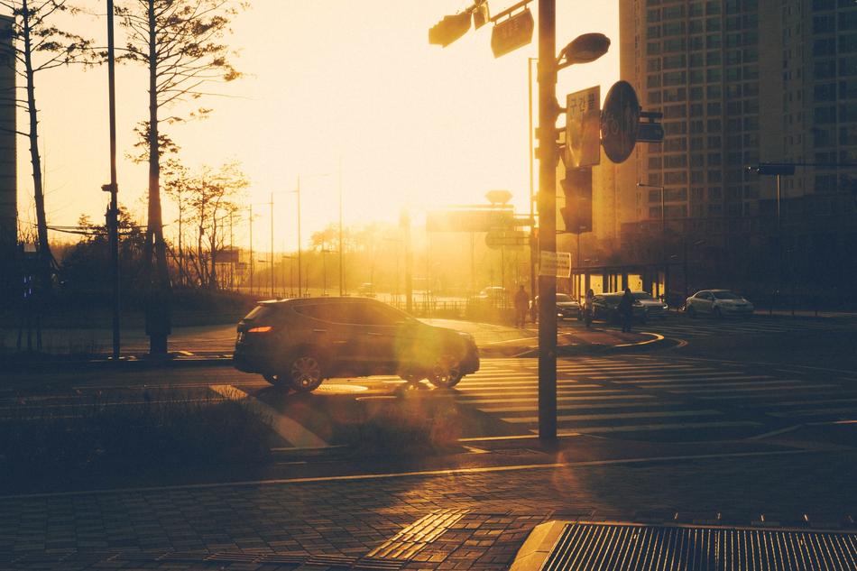 Beautiful road with the cars, in the colorful sunlight, in the evening