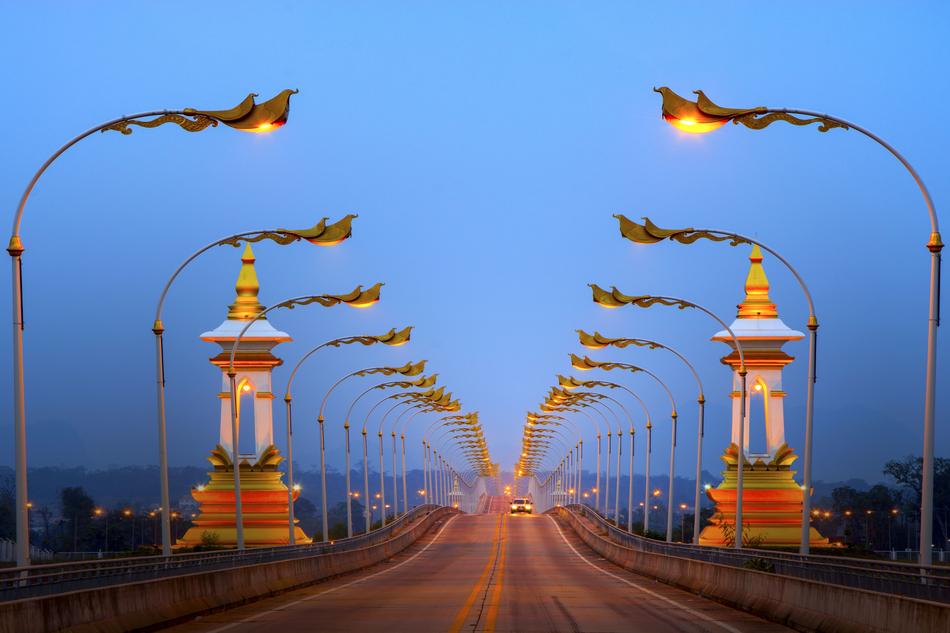 Beautiful landscape of the bridge with colorful lights and cars, in the evening