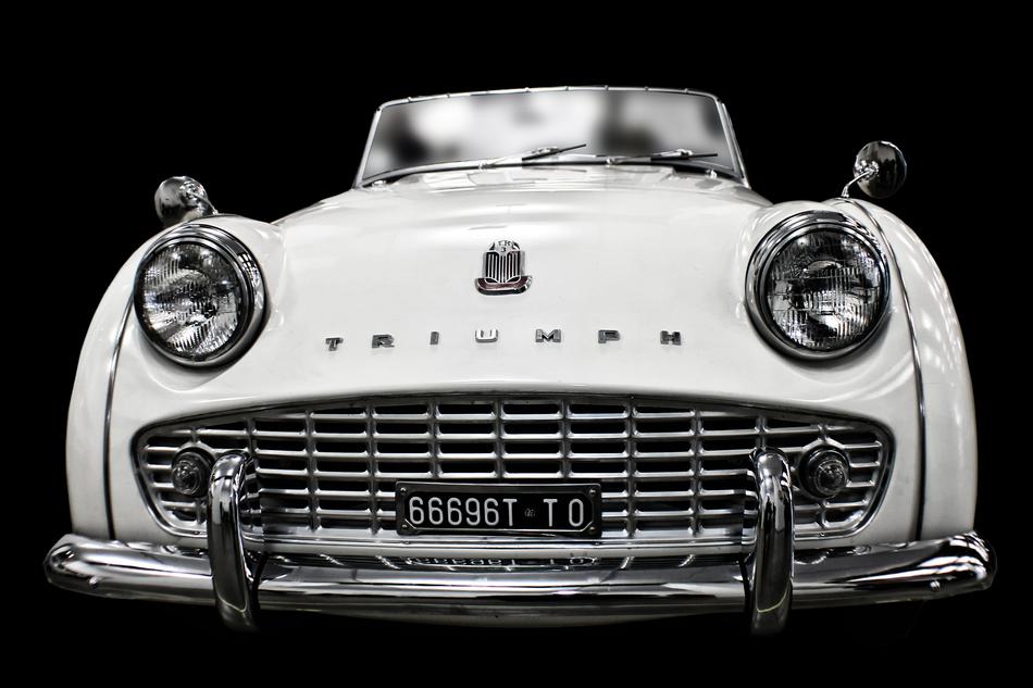 white vintage car on black background