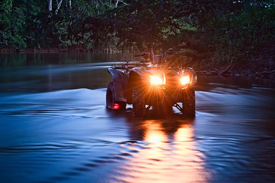 Atv on the river at dusk