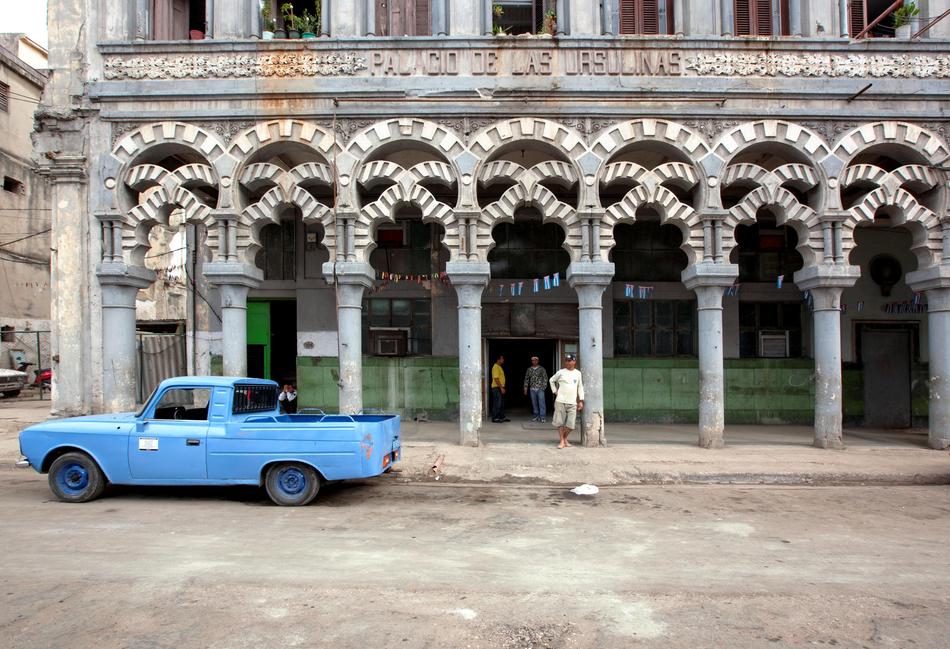 vintage car parked near the building with columns