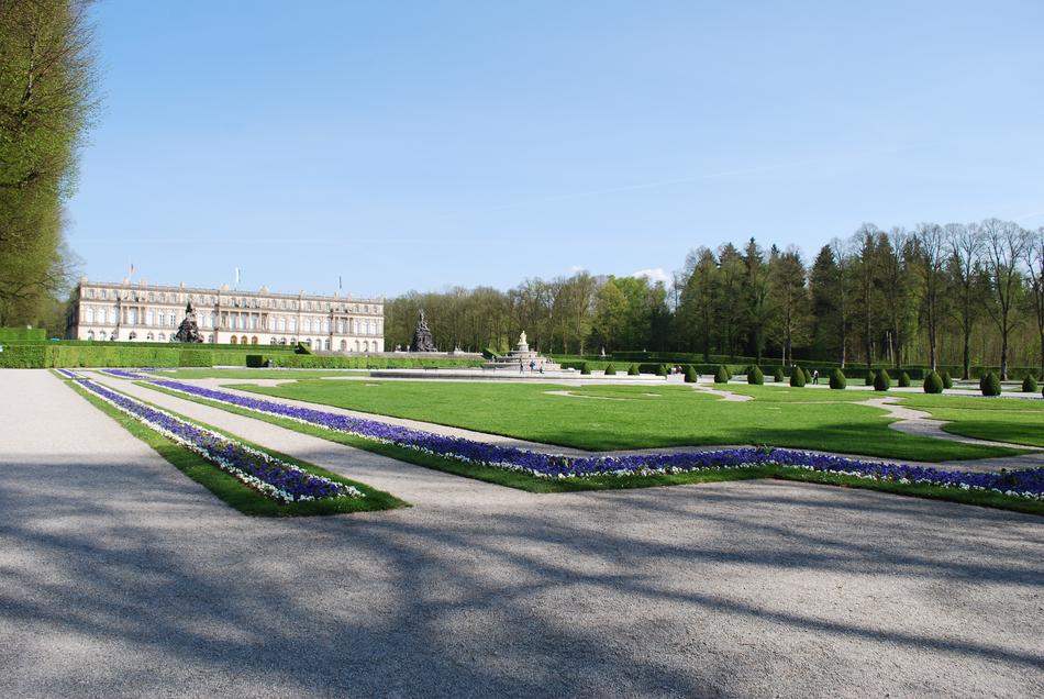 Beautiful landscape with the road, among the green fields and trees, near the building