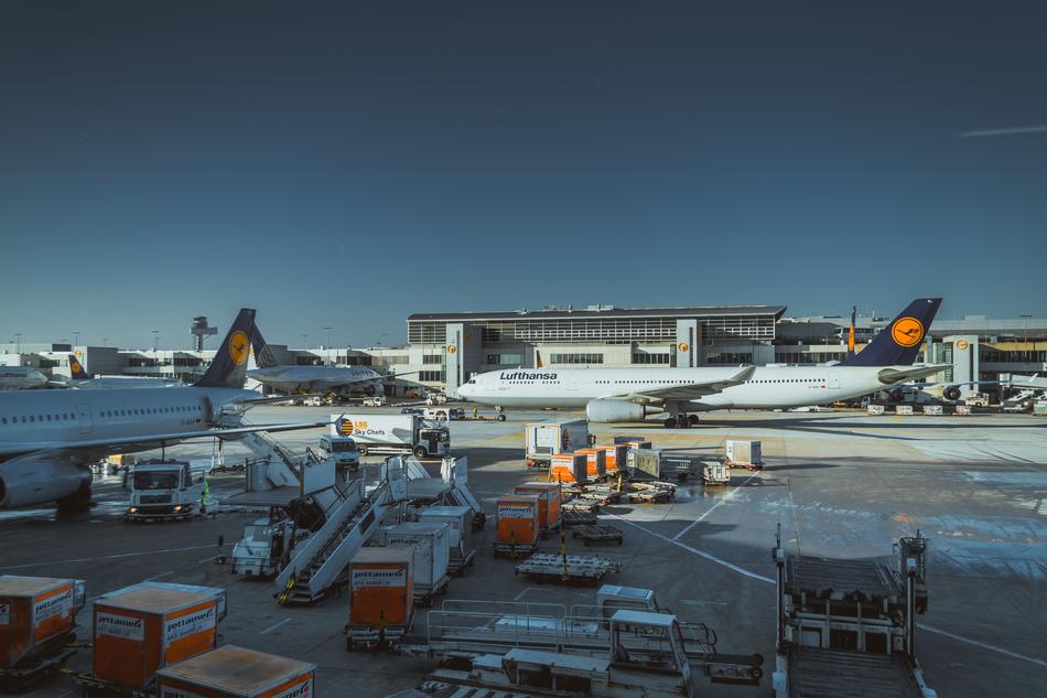 containers near lufthansa Airplanes in airport