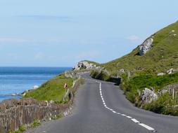 road on the coast of ireland on a sunny day