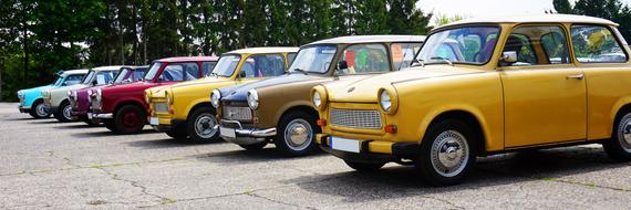 Colorful, vintage, shiny "Trabant Trabi" cars in the row, in light