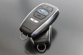 Close-up of the two Subaru car keys with key rings