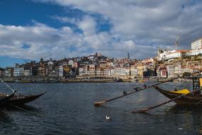 traditional boats anchored in view of city, brazil, rio de janeiro