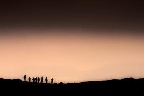 people at the peak of a mountain in slovakia at dusk