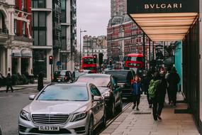 people and cars on a city street in london