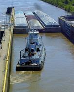 tugboat on the water in front of locks