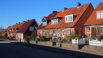 residential buildings near the road under the blue sky