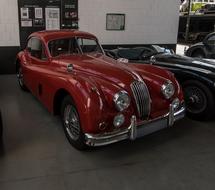 Beautiful, shiny, red Jaguar car, near the other cars