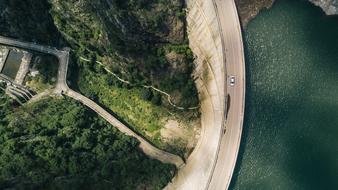 bird's eye view of the road along the lake and forest