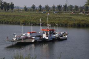 Boat with the flag, on the river, among the colorful and beautiful plants