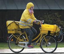 Postal Delivery, mailwoman riding bicycle, germany