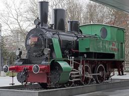 Beautiful, old and colorful train, among the trees, outdoors