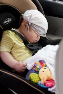 Boy, with the colorful toys, sitting in the vehicle