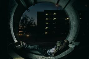 lonely man sleeping outside in the dark